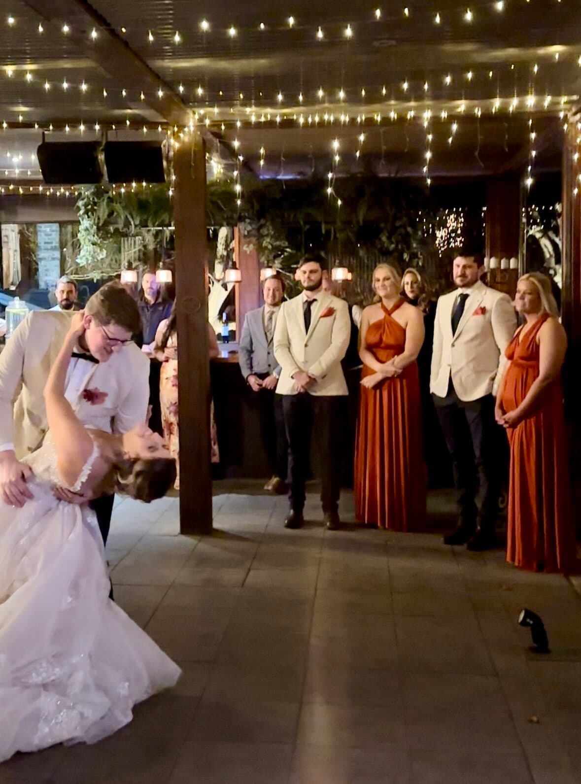 Wedding first dance dip under fairy lights