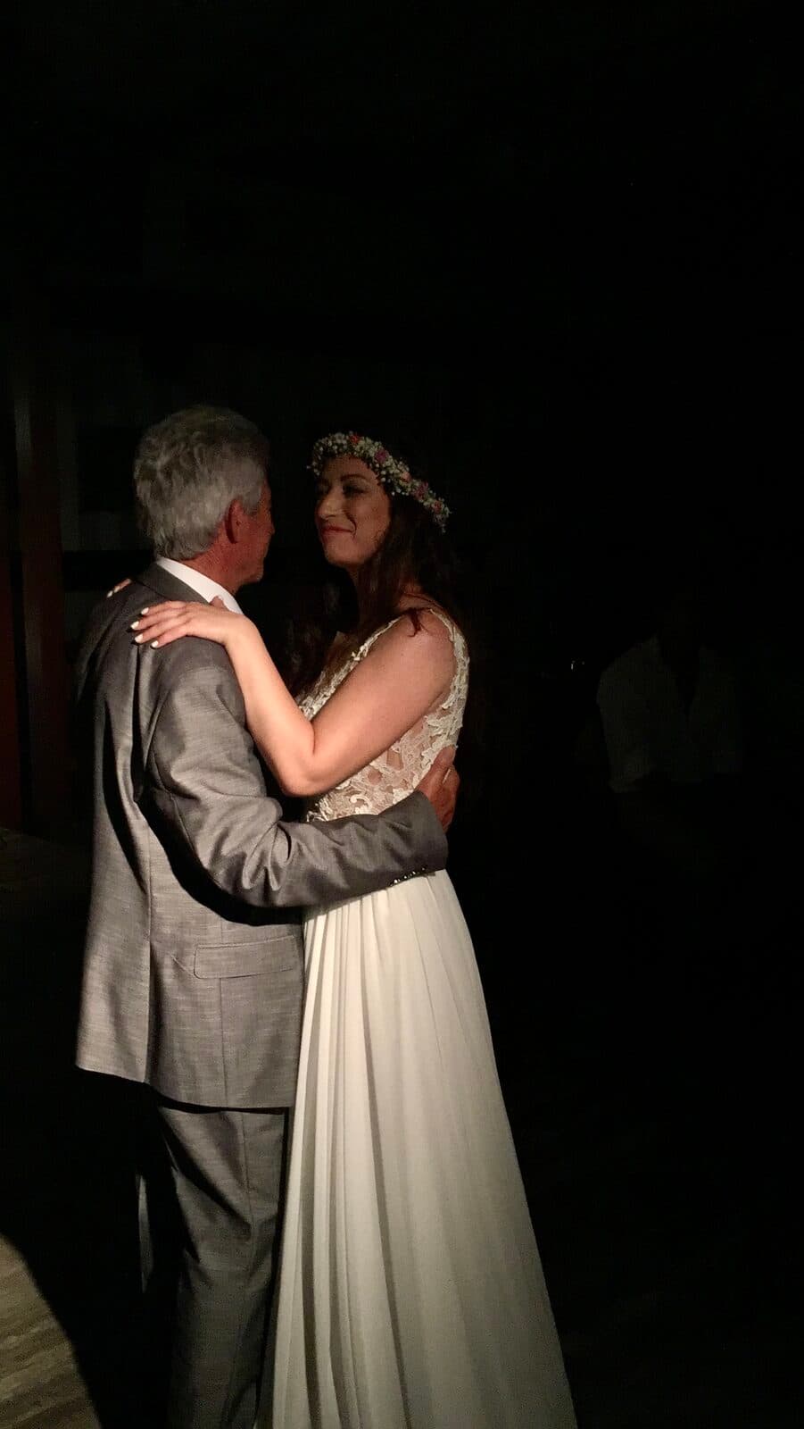 Father-daughter dance moment with flower crown